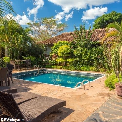 a backyard with a pool and a patio images by DPwalay