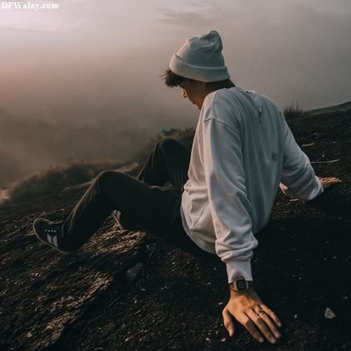 a man sitting on top of a mountain