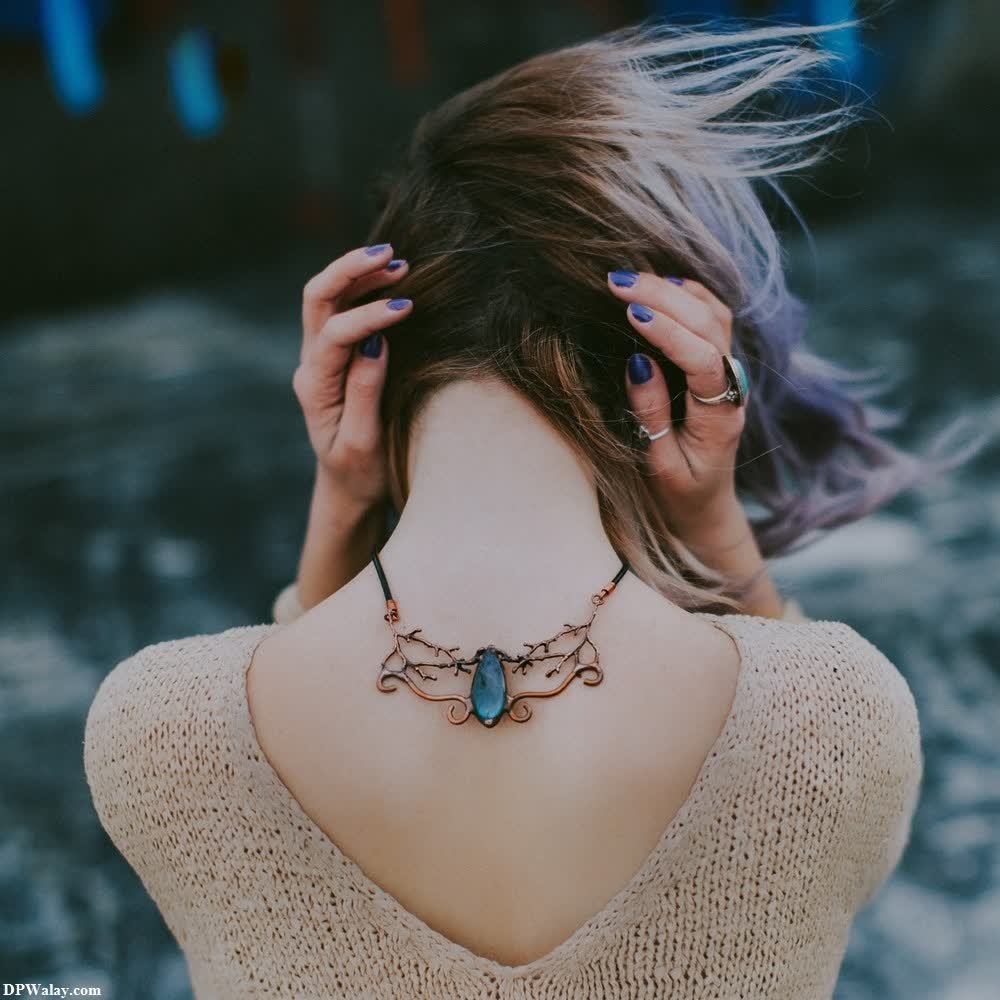 a woman with purple hair and a blue necklace alone wp dp 