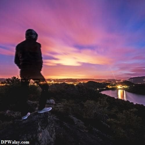 a person standing on top of a mountain at sunset attitude alone dp