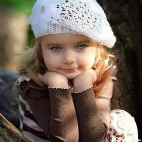 a little girl wearing a white hat and brown dress images by DPwalay