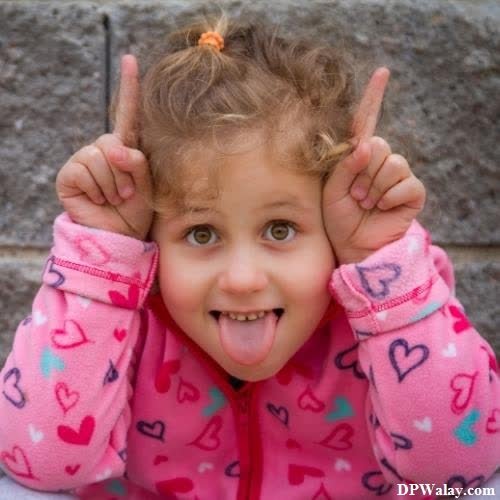 whatsapp dp cute baby girl - a little girl with her hands up and making a heart