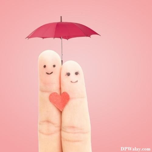 two fingers holding a red umbrella with a heart on it images by DPwalay