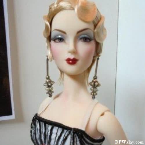 a doll with blonde hair and a black dress