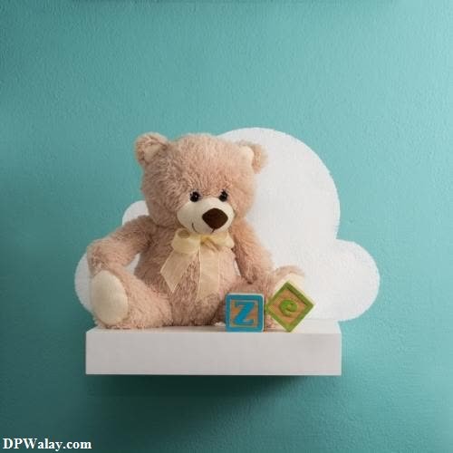 a teddy bear sitting on top of a shelf images by DPwalay