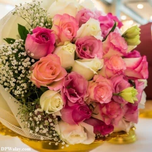 a bouquet of pink and white roses on a table beautiful flowers dp 