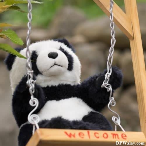 a stuffed panda bear on a swing