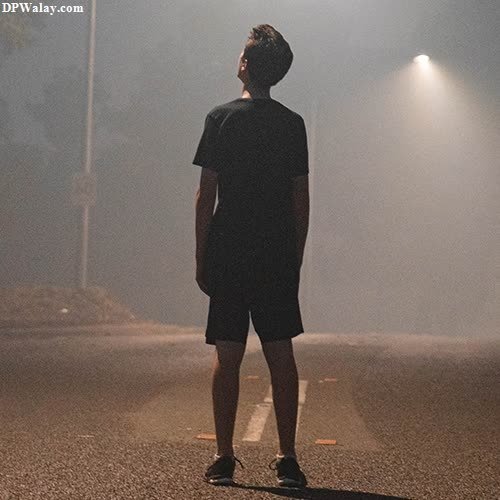 alone whatsapp dp - a man standing on the street in the fog