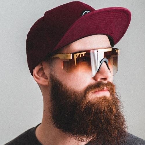 a man with a beard wearing a hat and sunglasses 