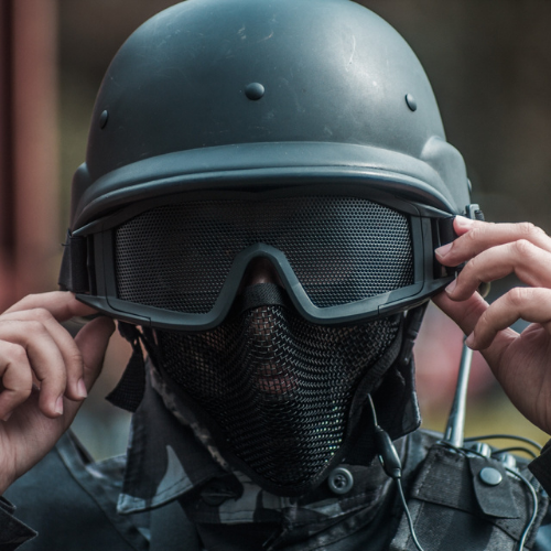 a man wearing a helmet and holding a cell