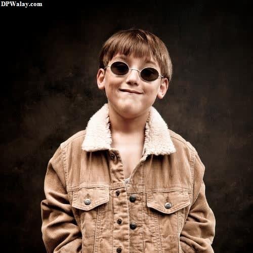 cool whatsapp dp - a young boy wearing sunglasses and a jacket