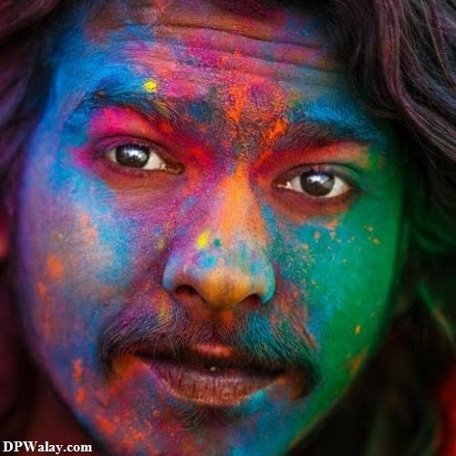 a man with his face covered in colorful powder images by DPwalay