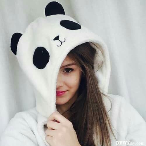 a woman wearing a panda hat