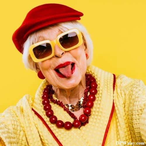 cool whatsapp dp - an older woman wearing sunglasses and a red hat