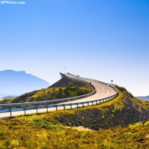 a road going through the mountains with a blue sky best wallpaper for whatsapp dp 
