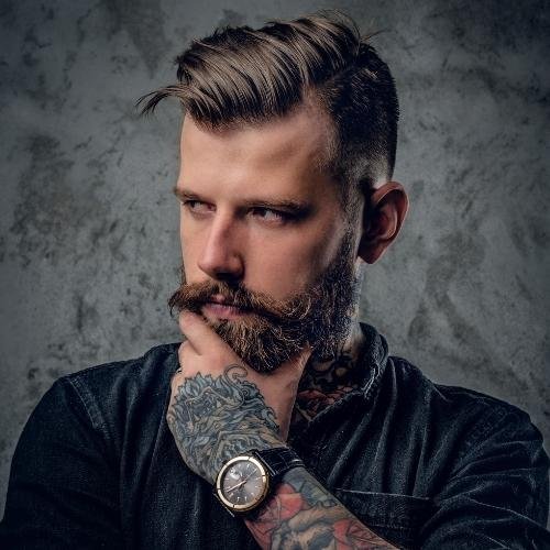 a man with a beard and tattoos 