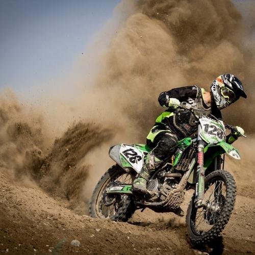 a person riding a dirt bike on a dirt trail images by DPwalay