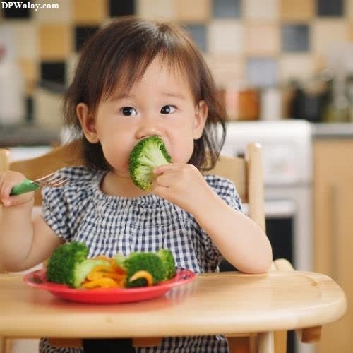 a little girl eating broccoccoccoccoccoccoccoccoccoccoccoccoccocco