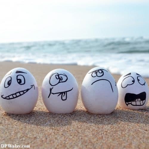three eggs with faces drawn on them on the beach images by DPwalay