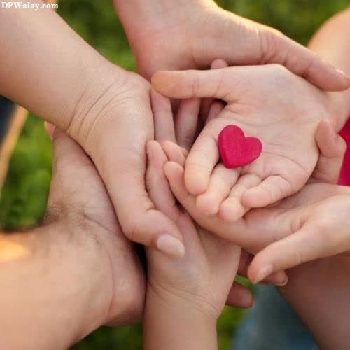 a family holding hands with a heart images by DPwalay