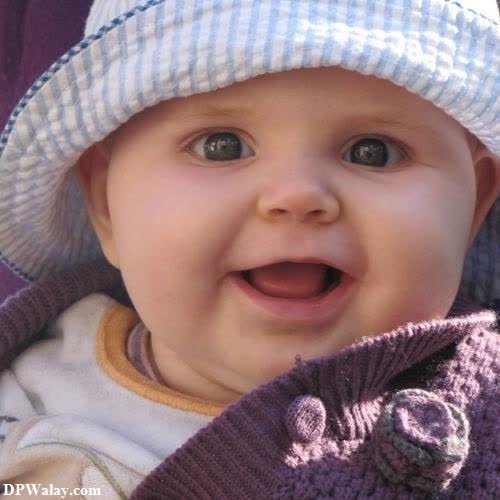 a baby wearing a hat and smiling cute baby girl pic for dp