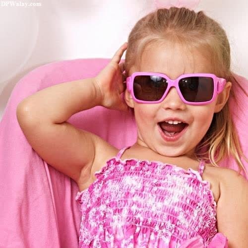 a little girl wearing sunglasses and smiling cute baby girl pic for dp 