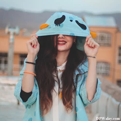 a woman in a blue hat and jacket cute beautiful dp for whatsapp