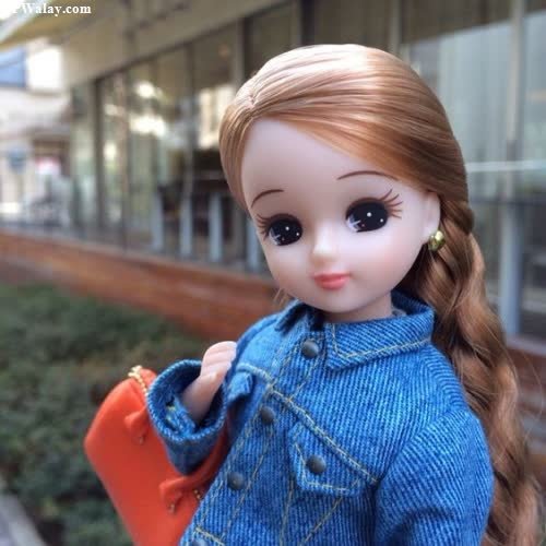 a doll with long hair and a blue sweater 