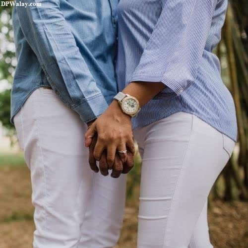 a couple holding hands in the park