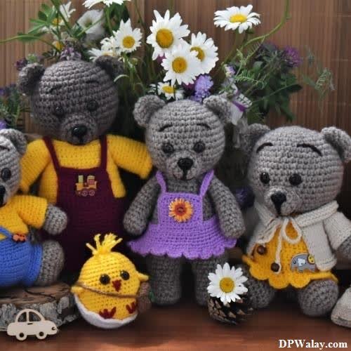 a group of stuffed animals sitting next to a bouquet of flowers images by DPwalay