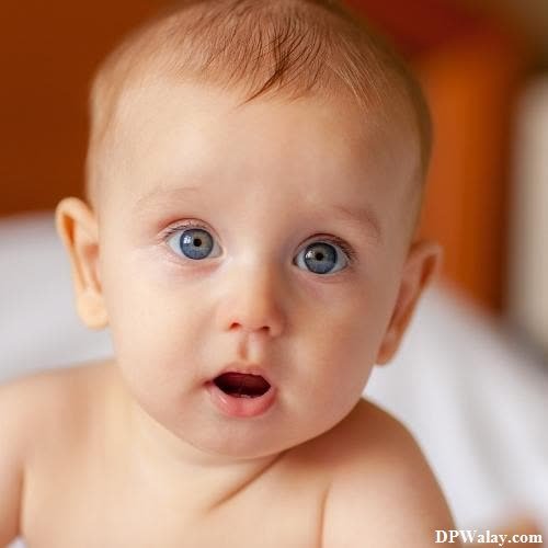cute whatsapp dp - a baby with blue eyes is looking up at the camera