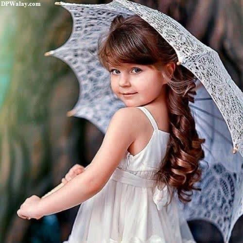 a little girl with an umbrella and a dress cute girl baby pic for dp 