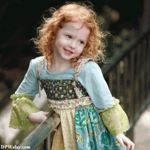 whatsapp dp cute baby girl - a little girl with red hair and a green dress