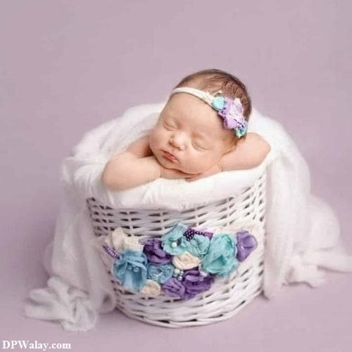 a baby girl sleeping in a basket with flowers cute girl baby pic for dp 