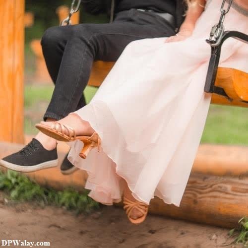 couple dp for whatsapp - a bride and groom sitting on a swing