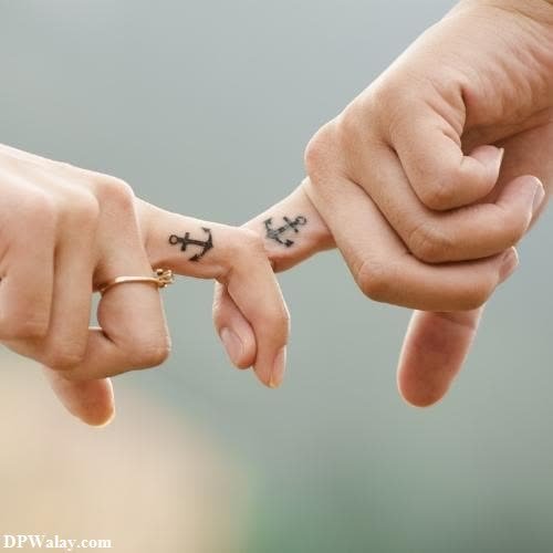 a couple holding hands with tattoos on their fingers images by DPwalay