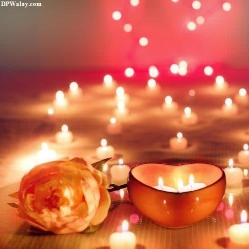 a candle and a bowl with candles on a table images by DPwalay