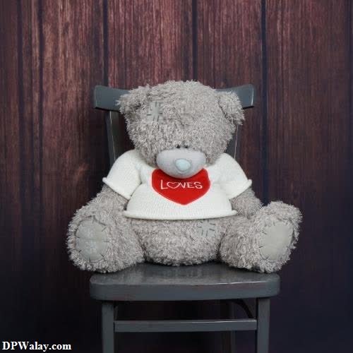 a teddy bear sitting on a chair with a heart cute nice whatsapp dp