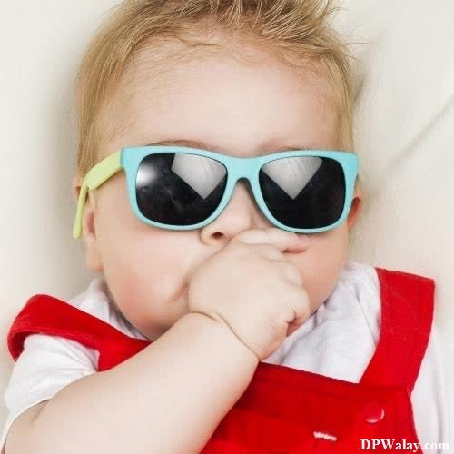 a little girl wearing sunglasses and a red vest cute nice whatsapp dp 