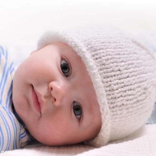 a baby wearing a knitted hat 