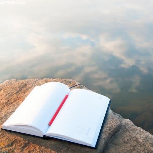 a book on a rock by the water cute wallpaper for whatsapp dp
