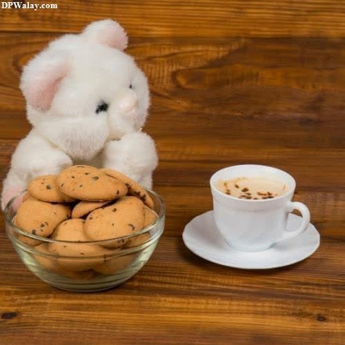 a small white mouse sitting on top of a table next to a bowl of cookies images by DPwalay
