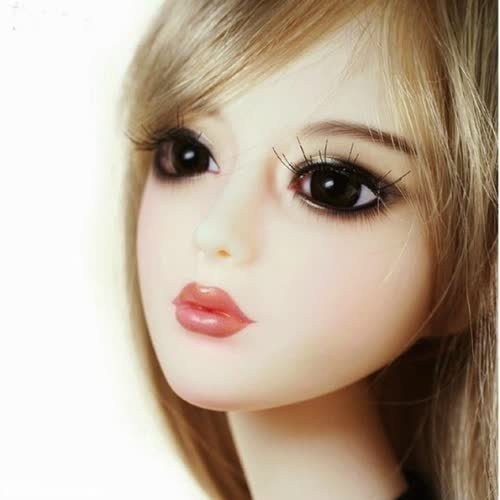 a doll with long blonde hair and a black shirt