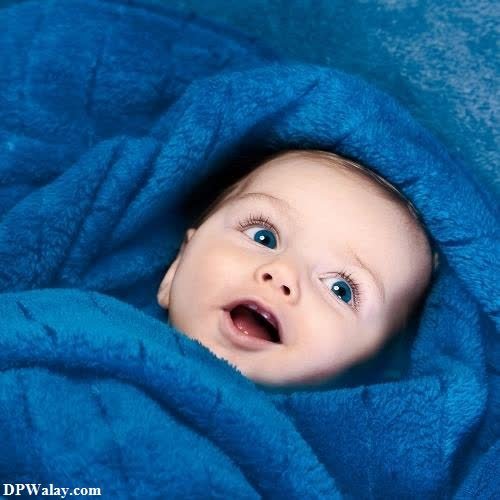 a baby wrapped in a blue blanket