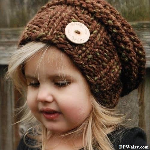 a little girl wearing a brown hat 