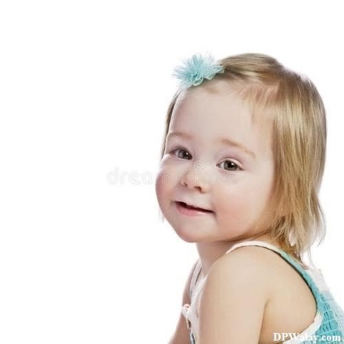 a little girl with a blue bow on her head stock images