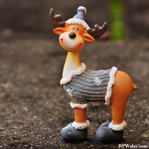 funny whatsapp dp - a small toy deer with a knitted sweater on it's back