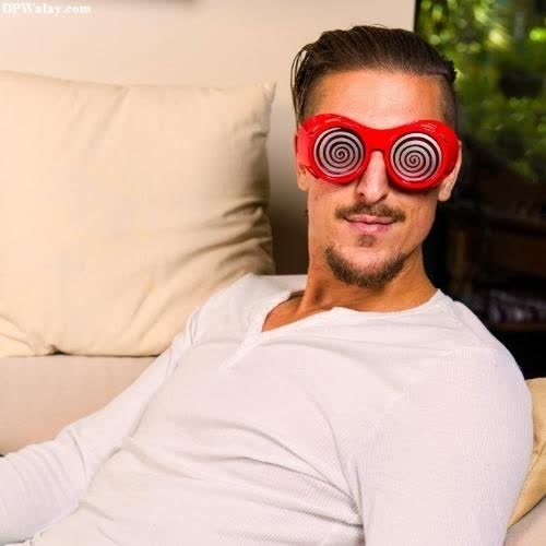 a man with a red eye mask on