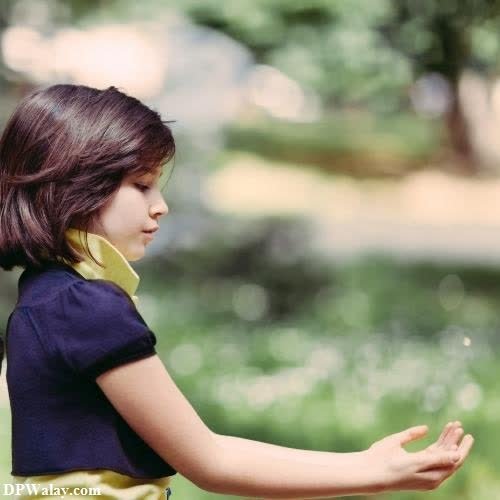 a little girl is standing in the grass girls dp download 