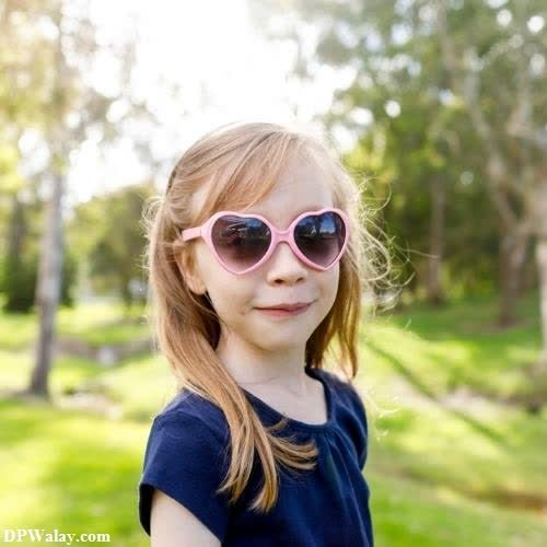 a little girl wearing sunglasses in the park